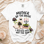 White t-shirt with "Mother of the Bride I Raised Her Not the Boo" graphic.