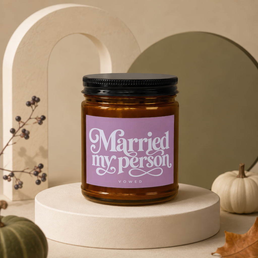 Amber jar candle with "Married my person" text on a purple label.