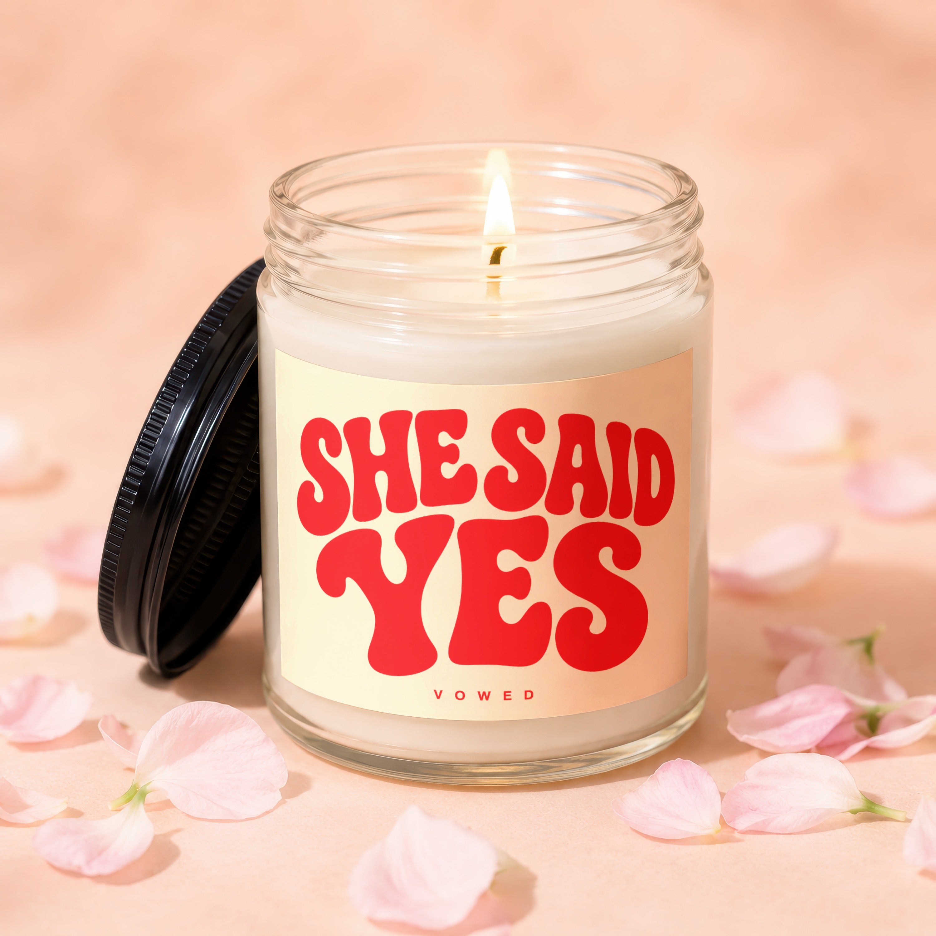 Glass candle with "She Said Yes" in red lettering and "Vowed" underneath.