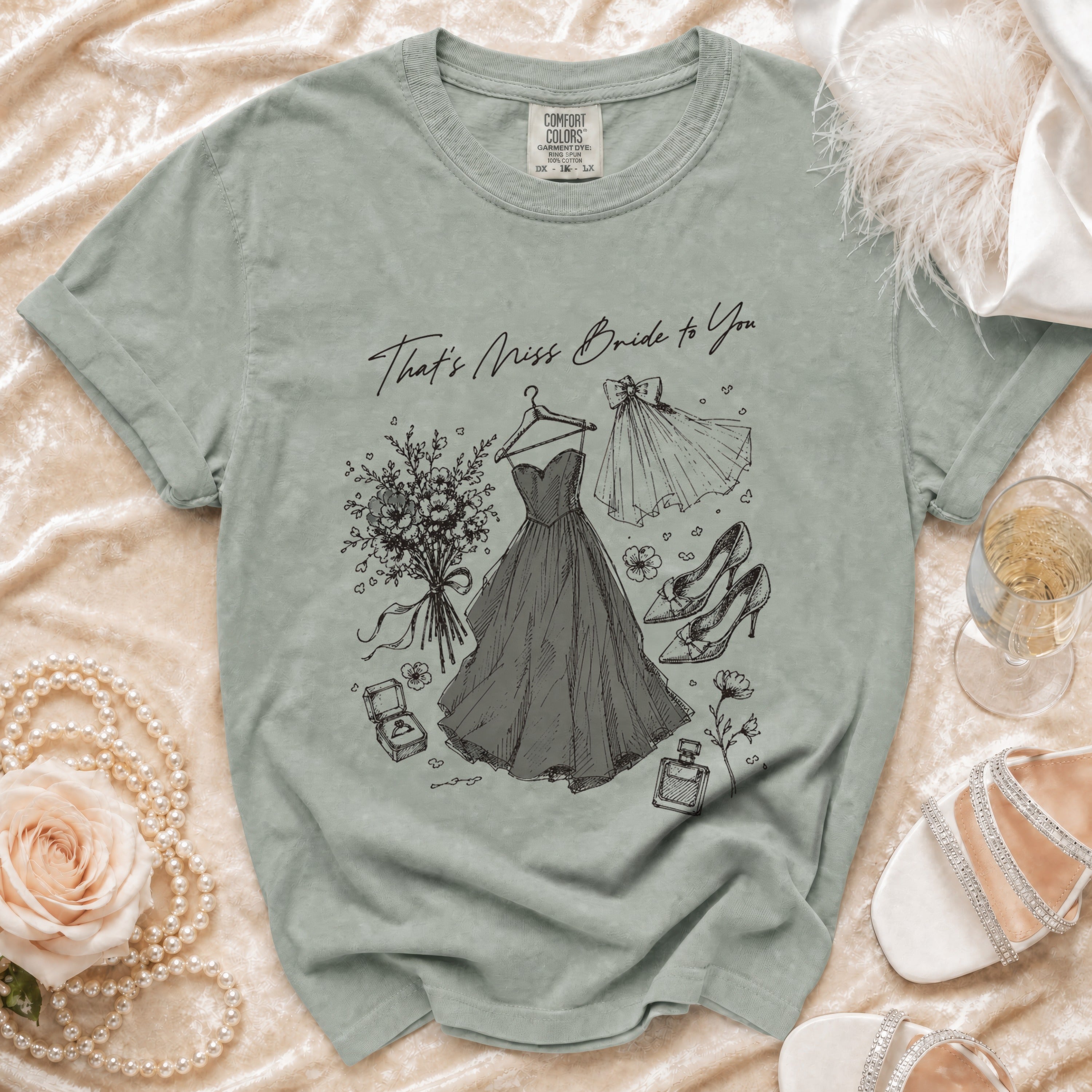 Gray t-shirt with "That's Miss Bride to You" and sketch of wedding dress, bouquet, and shoes.