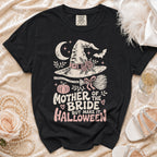 Black t-shirt with "Mother of the Bride But Make it Halloween" text and witchy graphics.