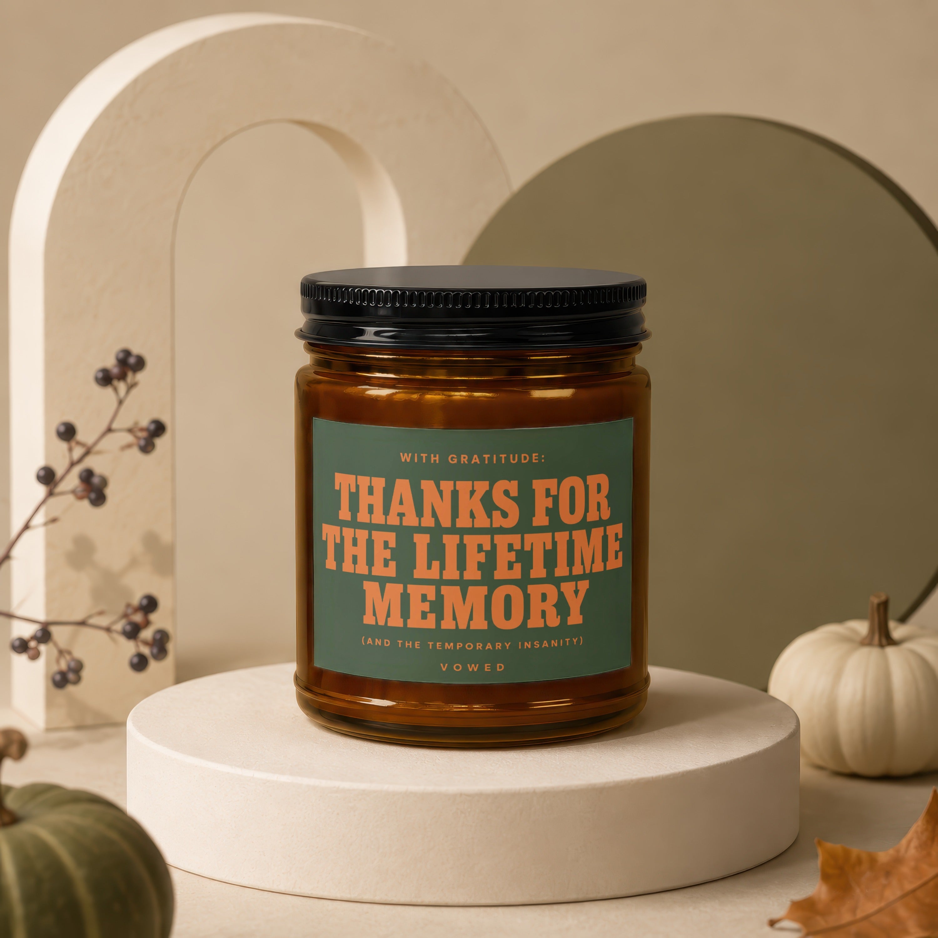 Amber candle with "Thanks for the lifetime memory" text in an autumnal setting.