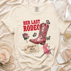 Cream t-shirt with "HER LAST RODEO" text and pink mosaic cowboy boot.