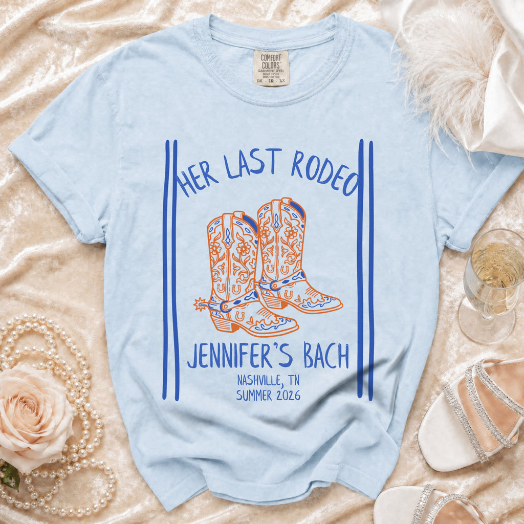 Light blue t-shirt with "Her Last Rodeo" and "Jennifer's Bach" text, cowboy boots graphic.