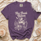 Purple t-shirt with "This Bride Bites" text and gothic bride graphic.