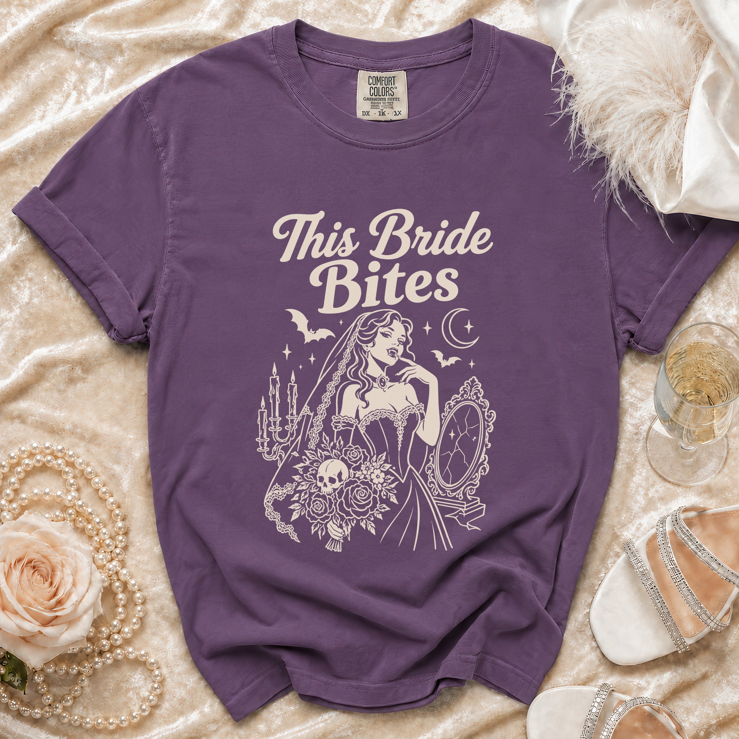 Purple t-shirt with "This Bride Bites" text and gothic bride graphic.