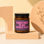 Brown candle with purple label reading "Together Is My Favorite Place" and "Vowed".