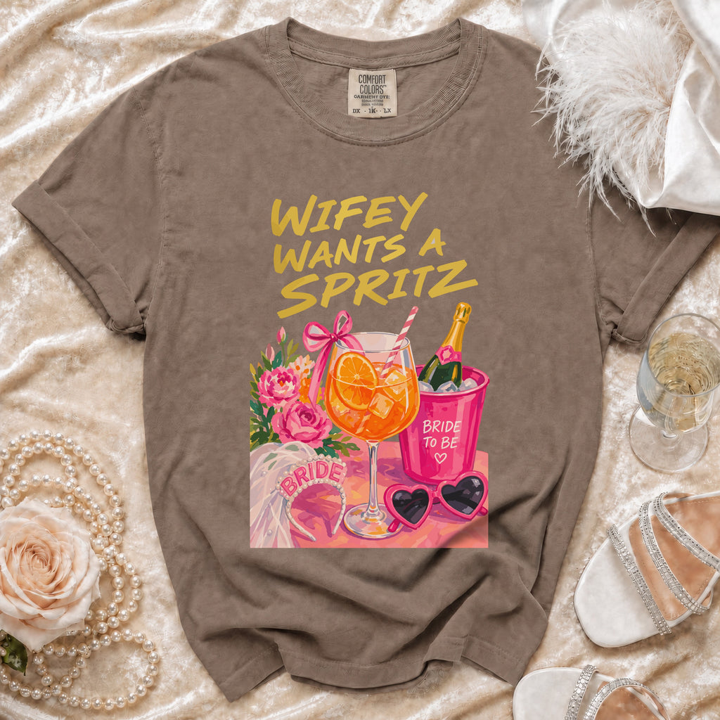 Brown t-shirt with "Wifey Wants A Spritz" graphic and bridal accessories.