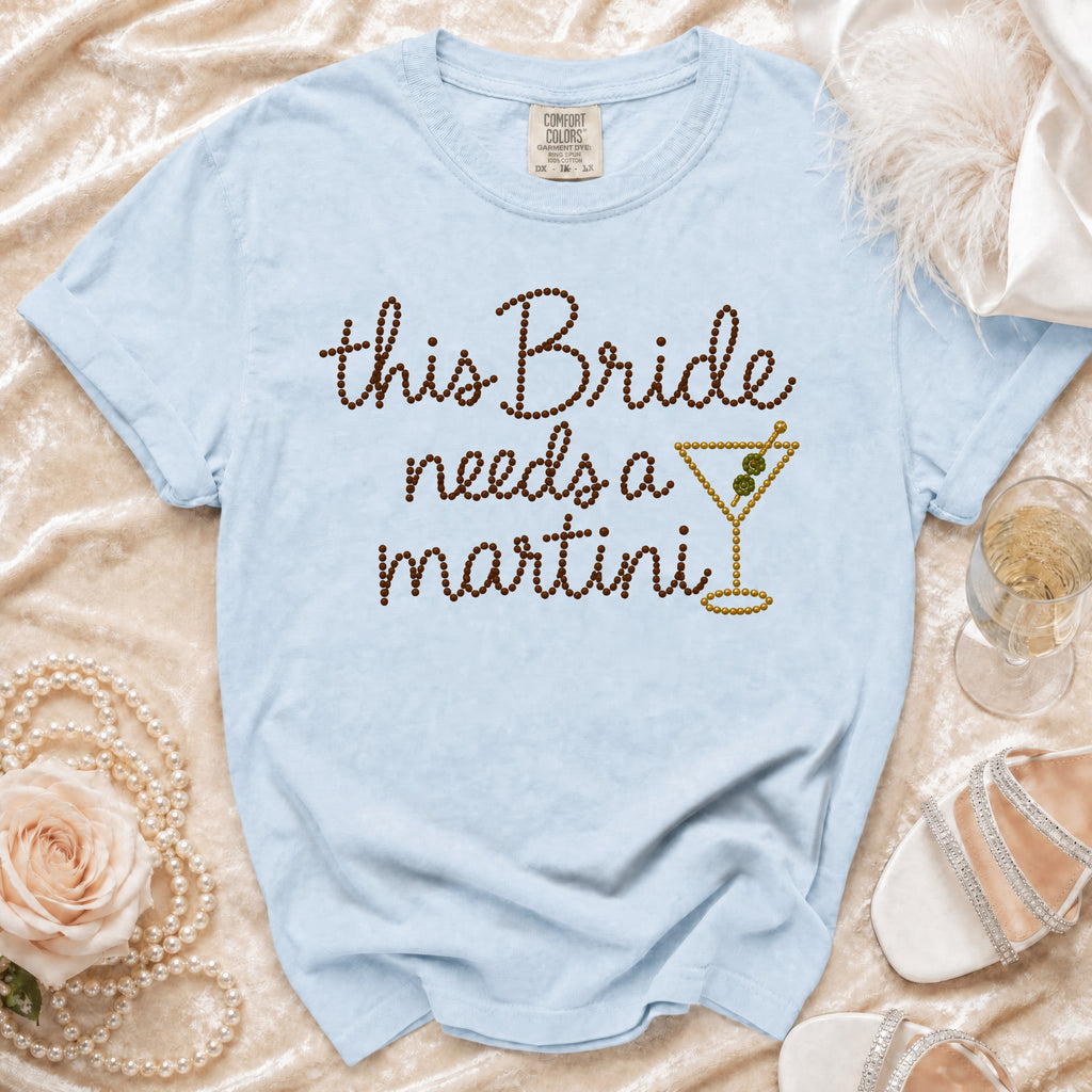 Light blue t-shirt with "This Bride needs a martini" text and martini glass design.