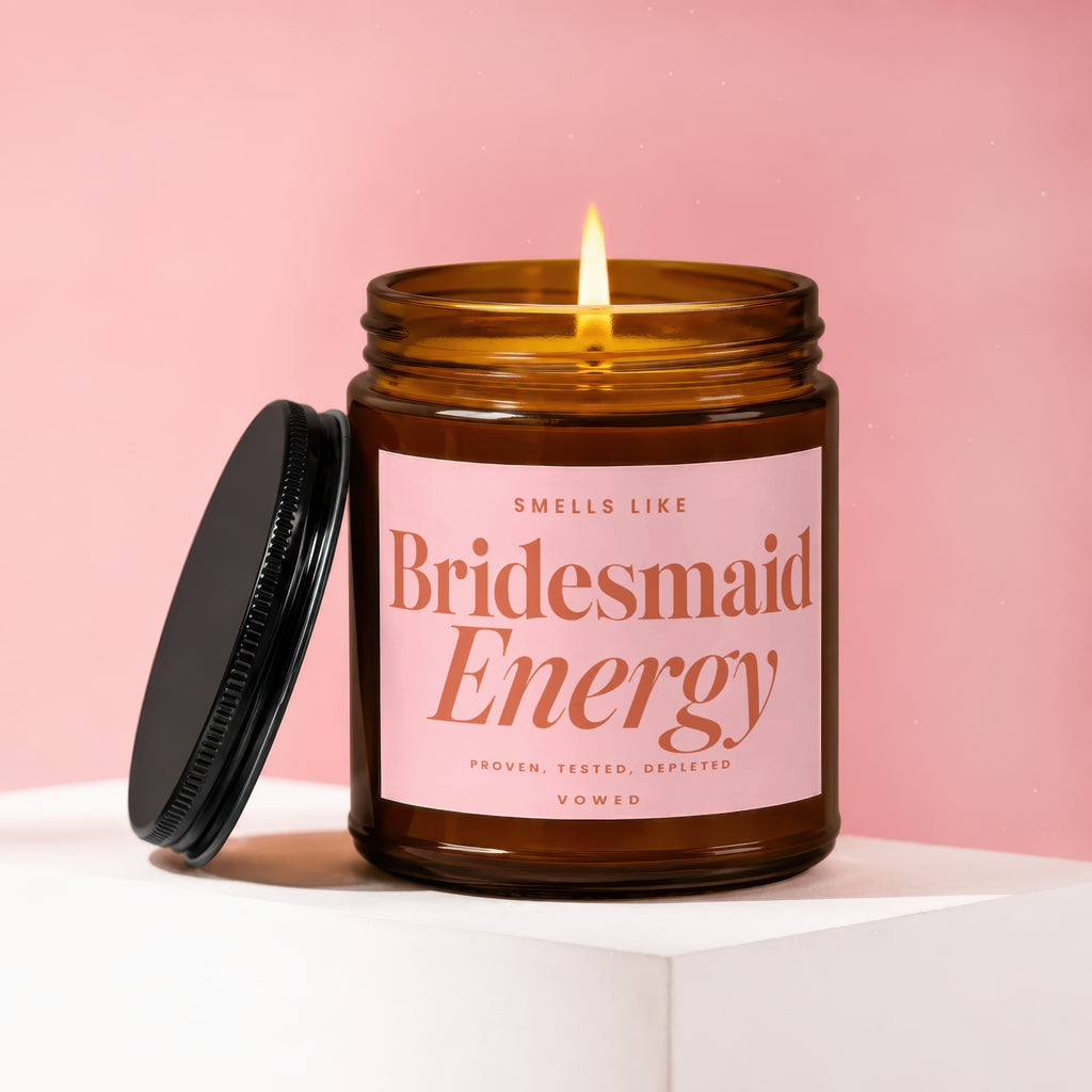Amber glass candle labeled "Smells Like Bridesmaid Energy".