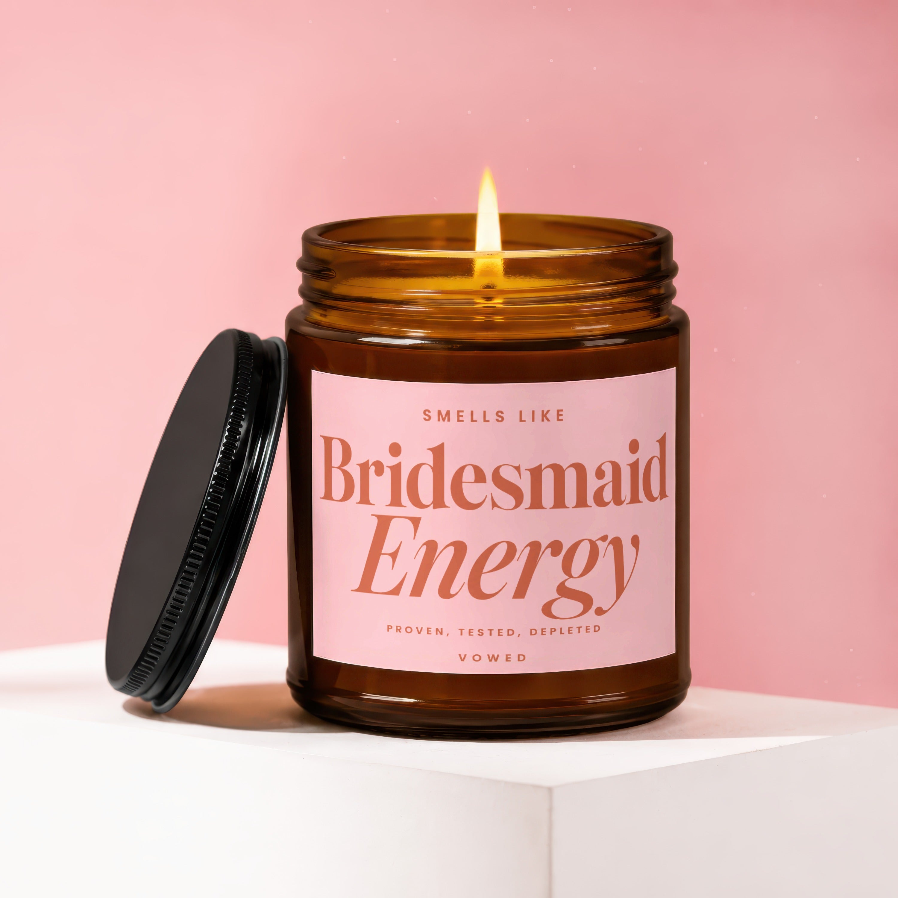 Amber glass candle labeled "Smells Like Bridesmaid Energy".