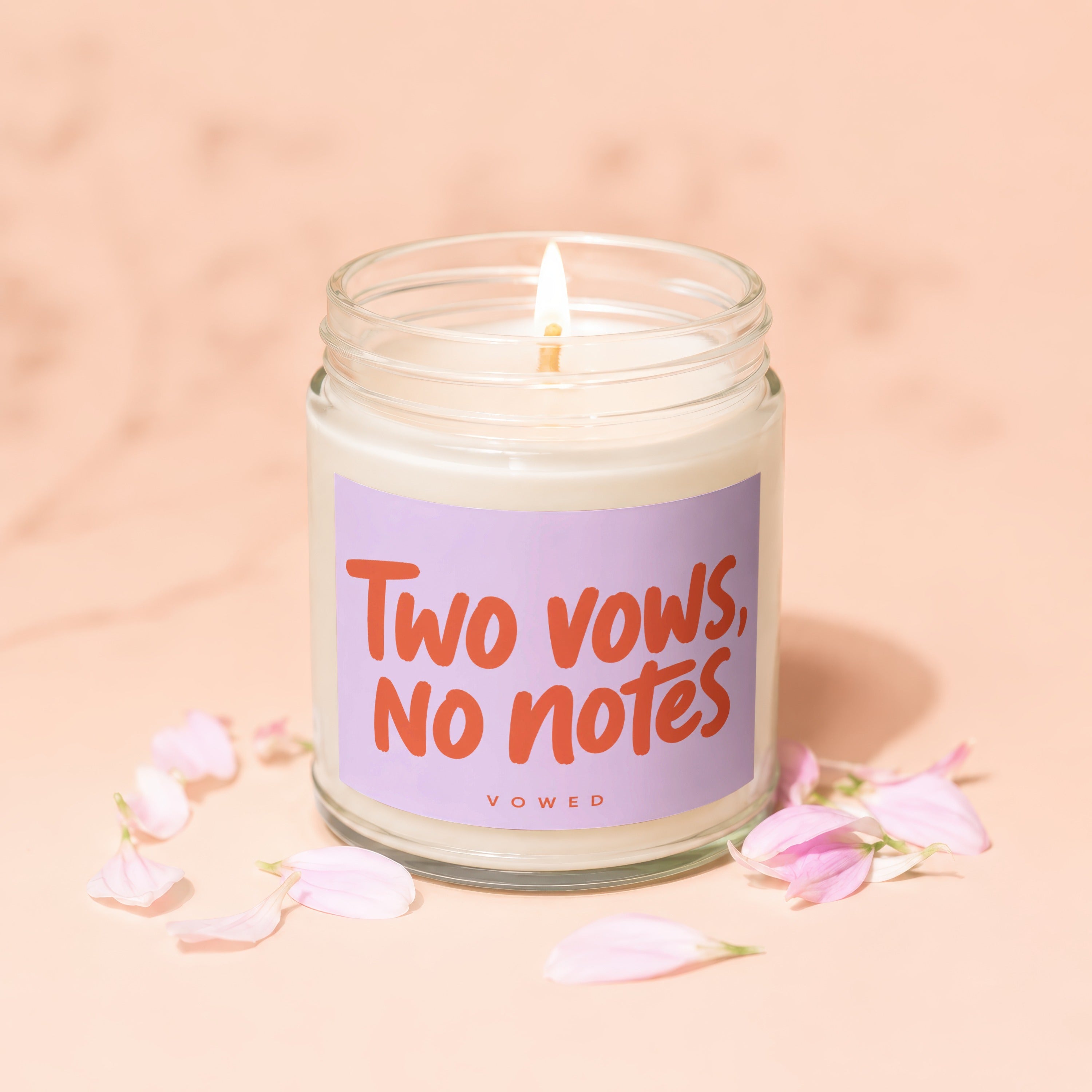 Candle with "Two vows, no notes" and "vowed" text on a purple label.