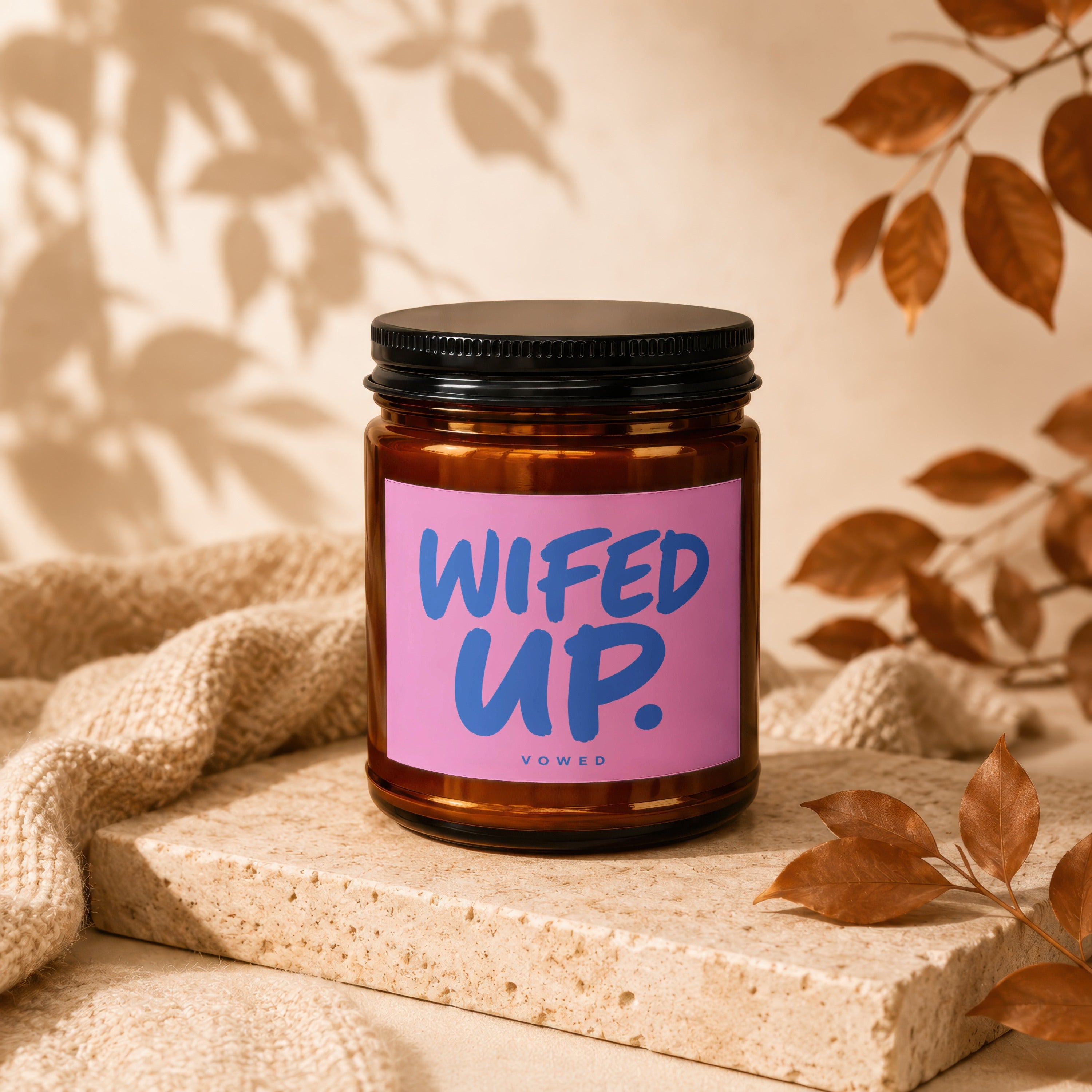 Amber candle with black lid, pink label reads "WIFED UP. VOWED".
