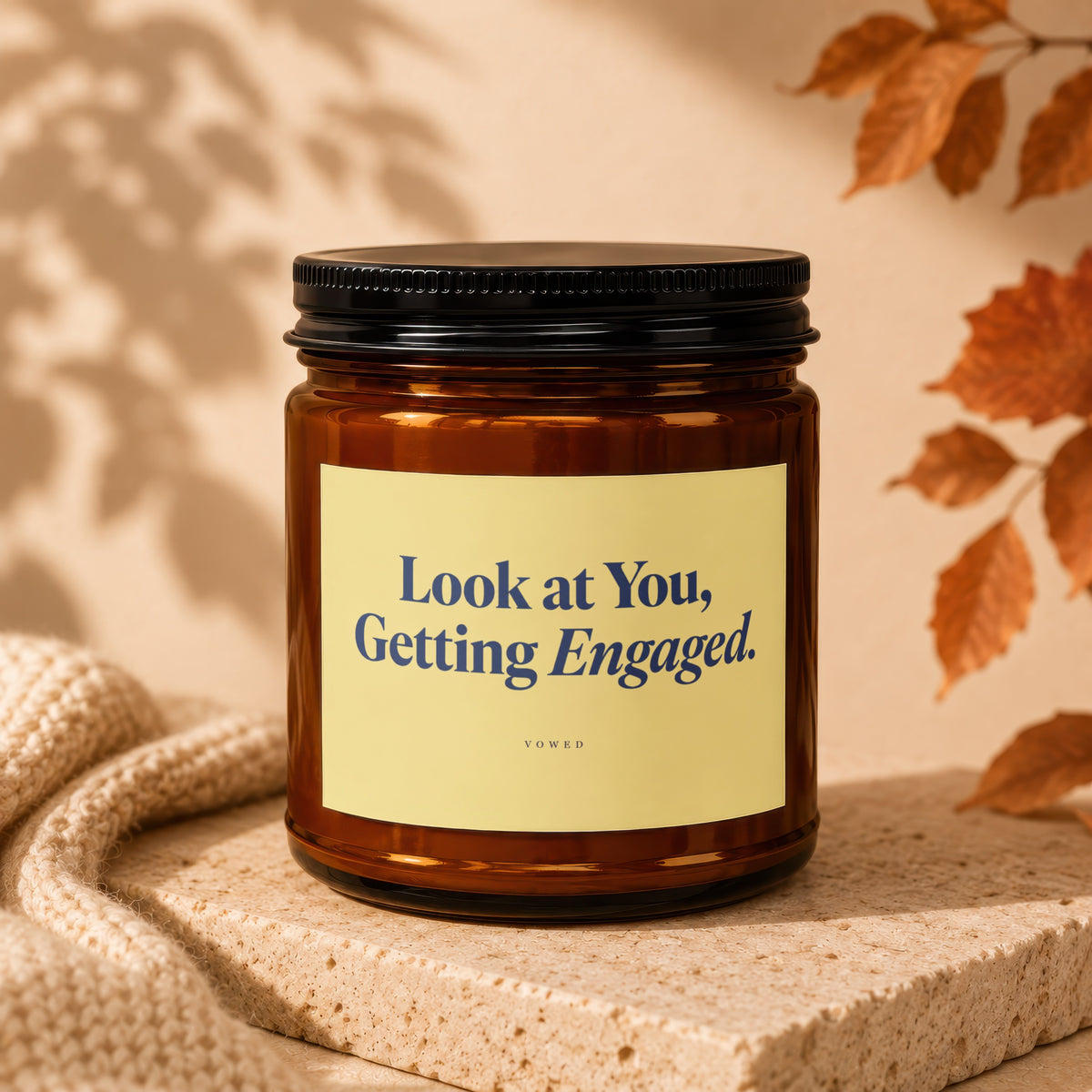 Amber candle with "Look at You, Getting Engaged." text on yellow label.
