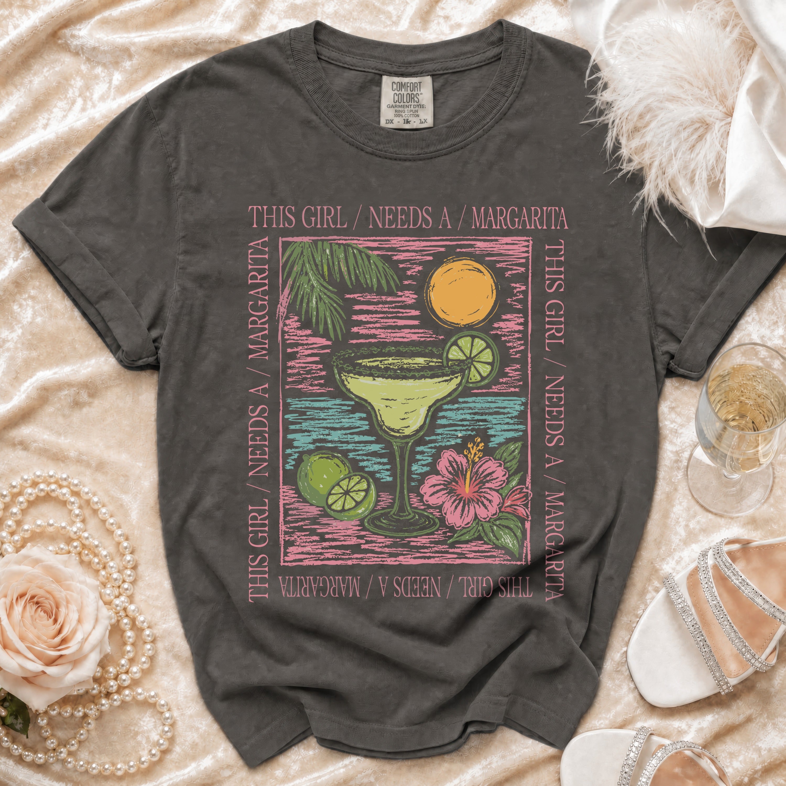 Gray t-shirt with "This Girl Needs A Margarita" text and tropical drink graphic.