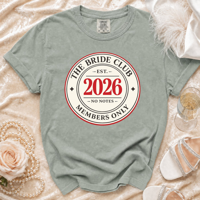 The Bride Club 2026 Members Only shirt with a pearl necklace and wedding heels.