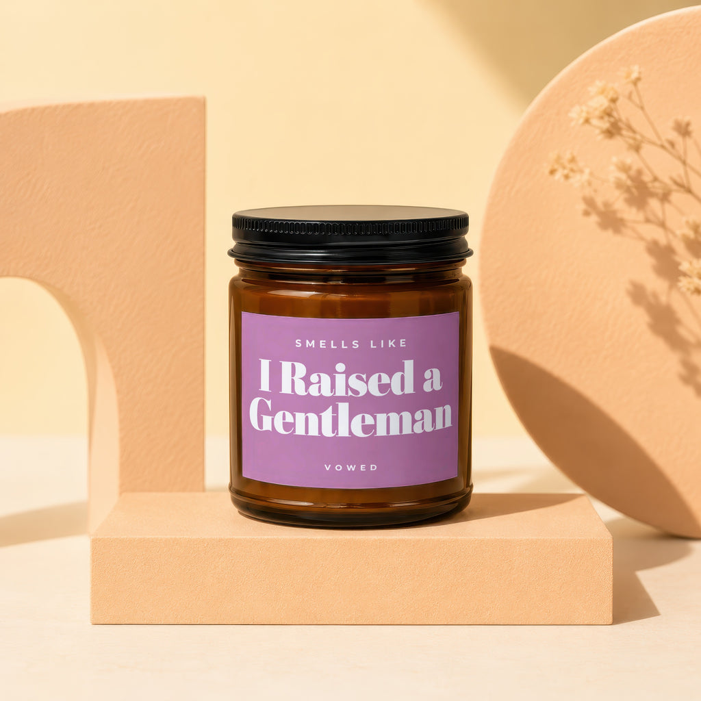 Brown glass candle, "I Raised a Gentleman" label, on display block.
