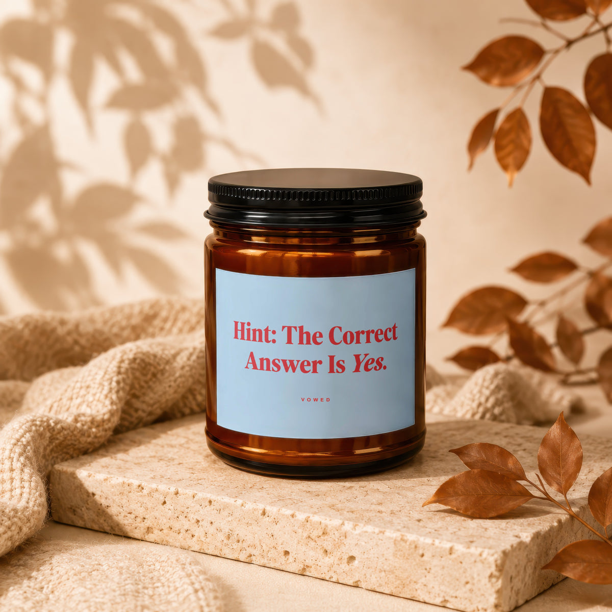Amber jar candle with "Hint: The Correct Answer Is Yes." text.