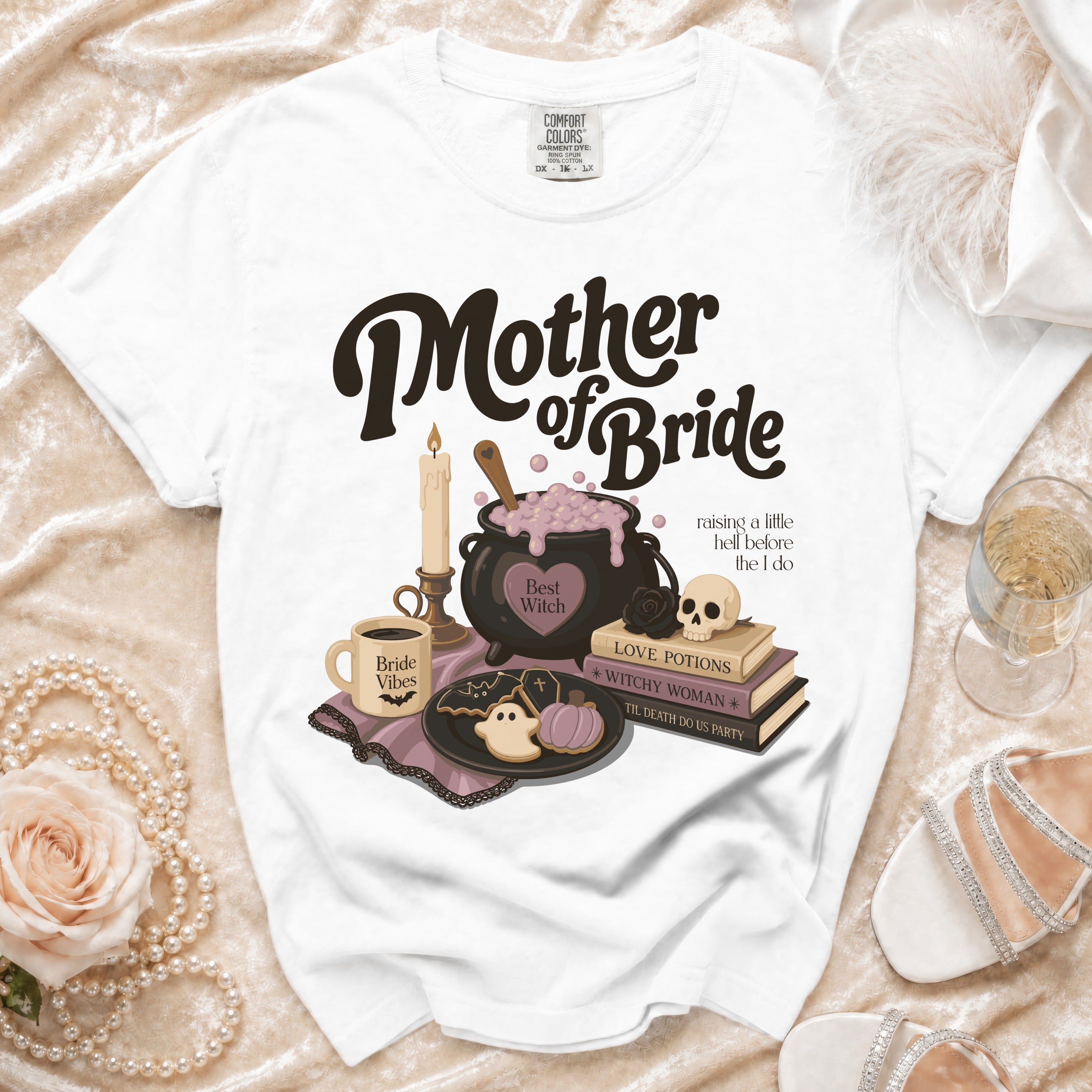 White t-shirt with "Mother of Bride" text and witchy Halloween-themed graphics.