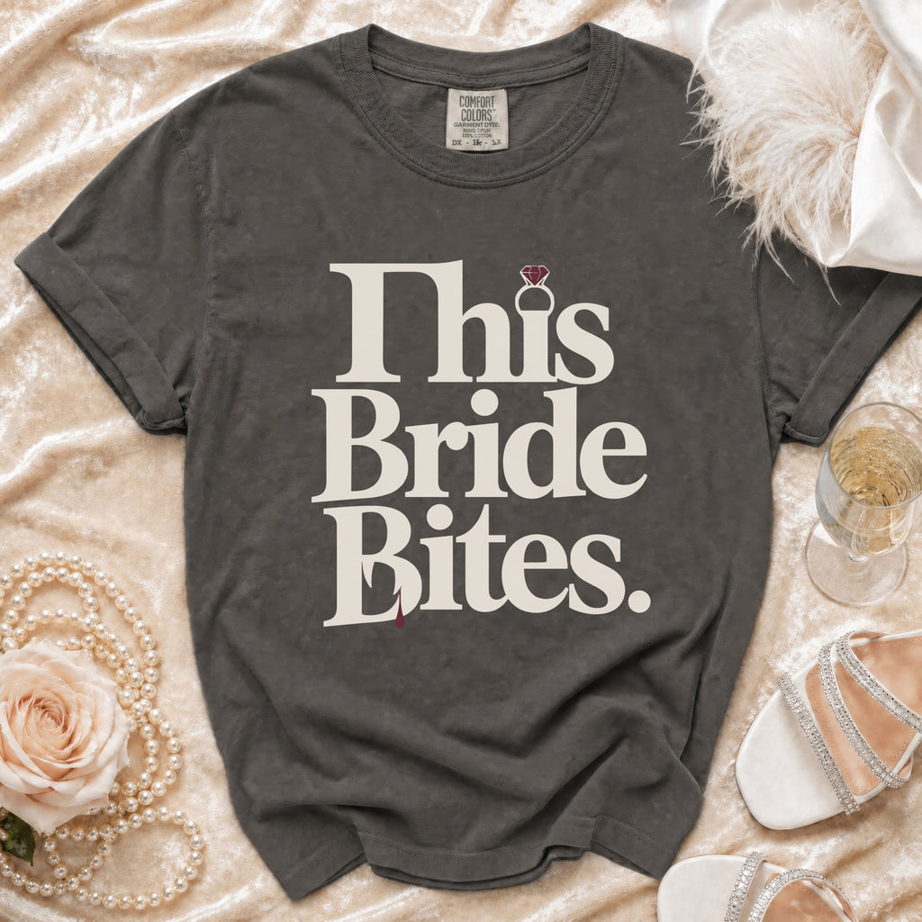 Grey t-shirt with "This Bride Bites" text, a diamond ring, and a red drop.