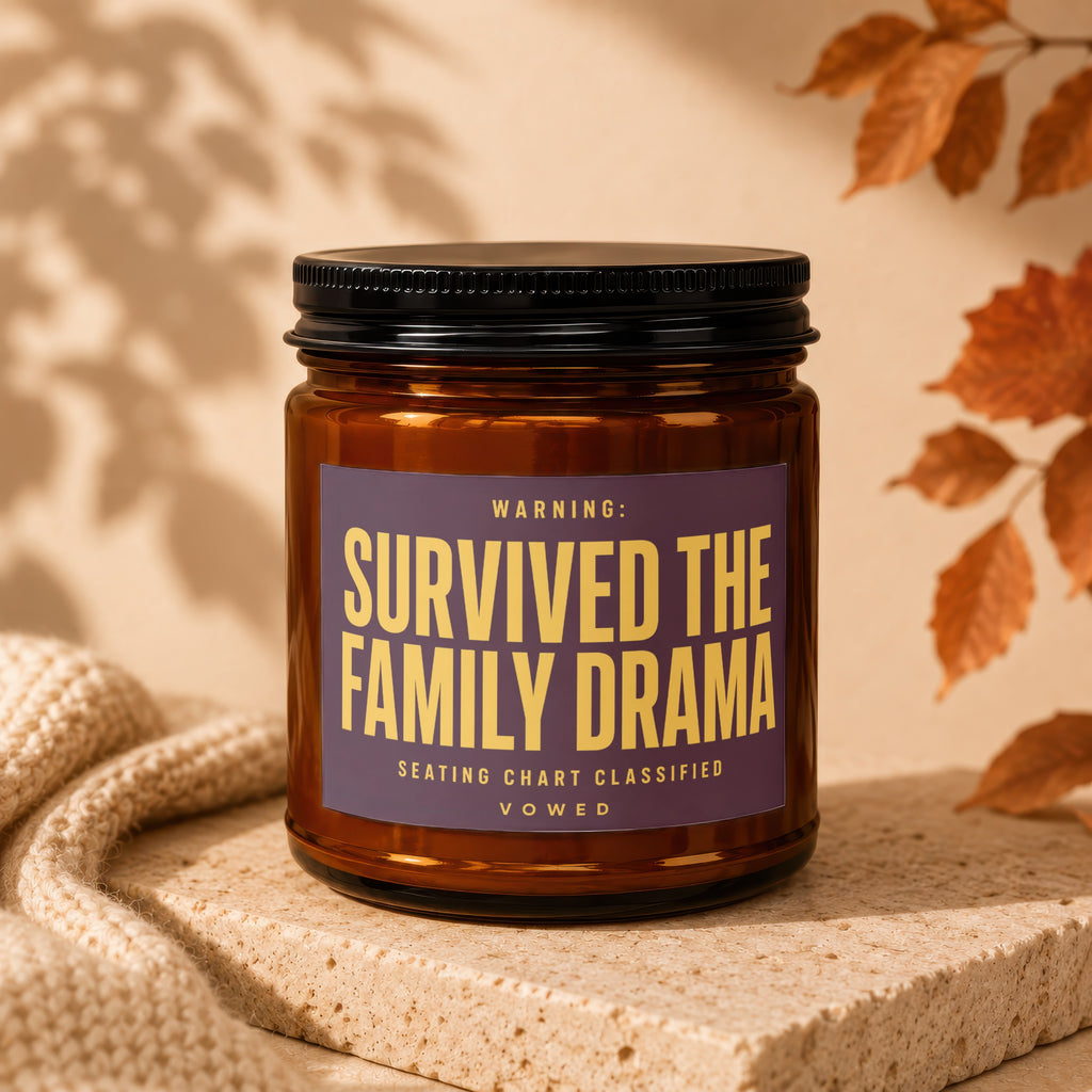 Amber jar candle with a label that reads "WARNING: SURVIVED THE FAMILY DRAMA SEATING CHART CLASSIFIED VOCWED".