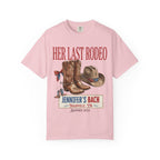 Pink t-shirt with "Her Last Rodeo" text, cowboy boots, and hat.