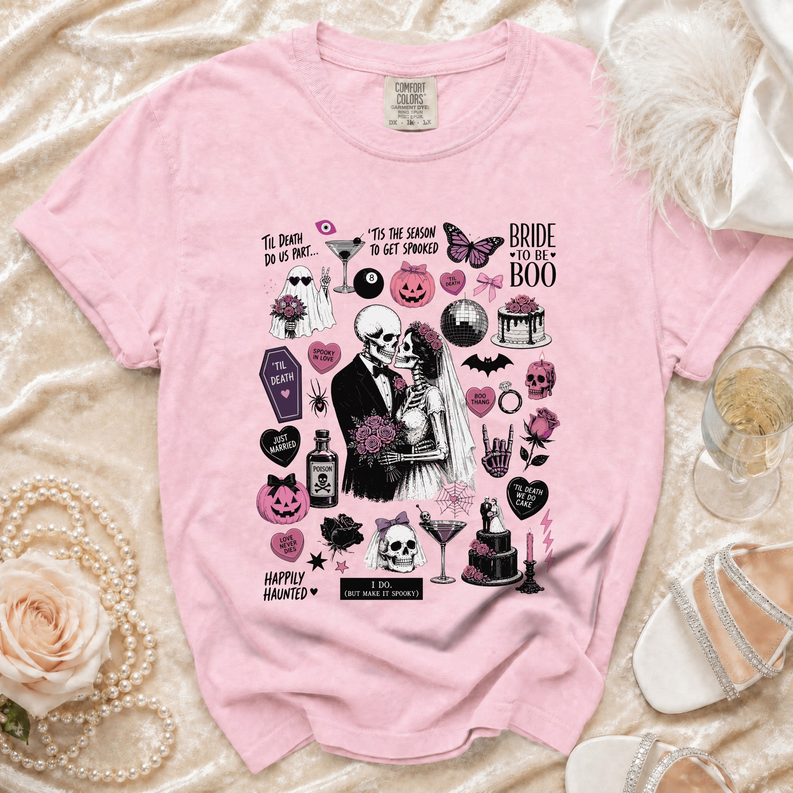 Pink t-shirt with skeleton bride and groom, Halloween motifs, and wedding text.