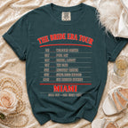 Dark teal t-shirt with "The Bride Era Tour Miami" and itinerary text.