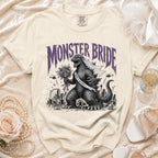 T-shirt with Godzilla as a bride, holding a bouquet, with text "MONSTER BRIDE".