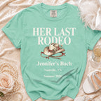 Mint green t-shirt with "Her Last Rodeo" text and rodeo hat graphic.