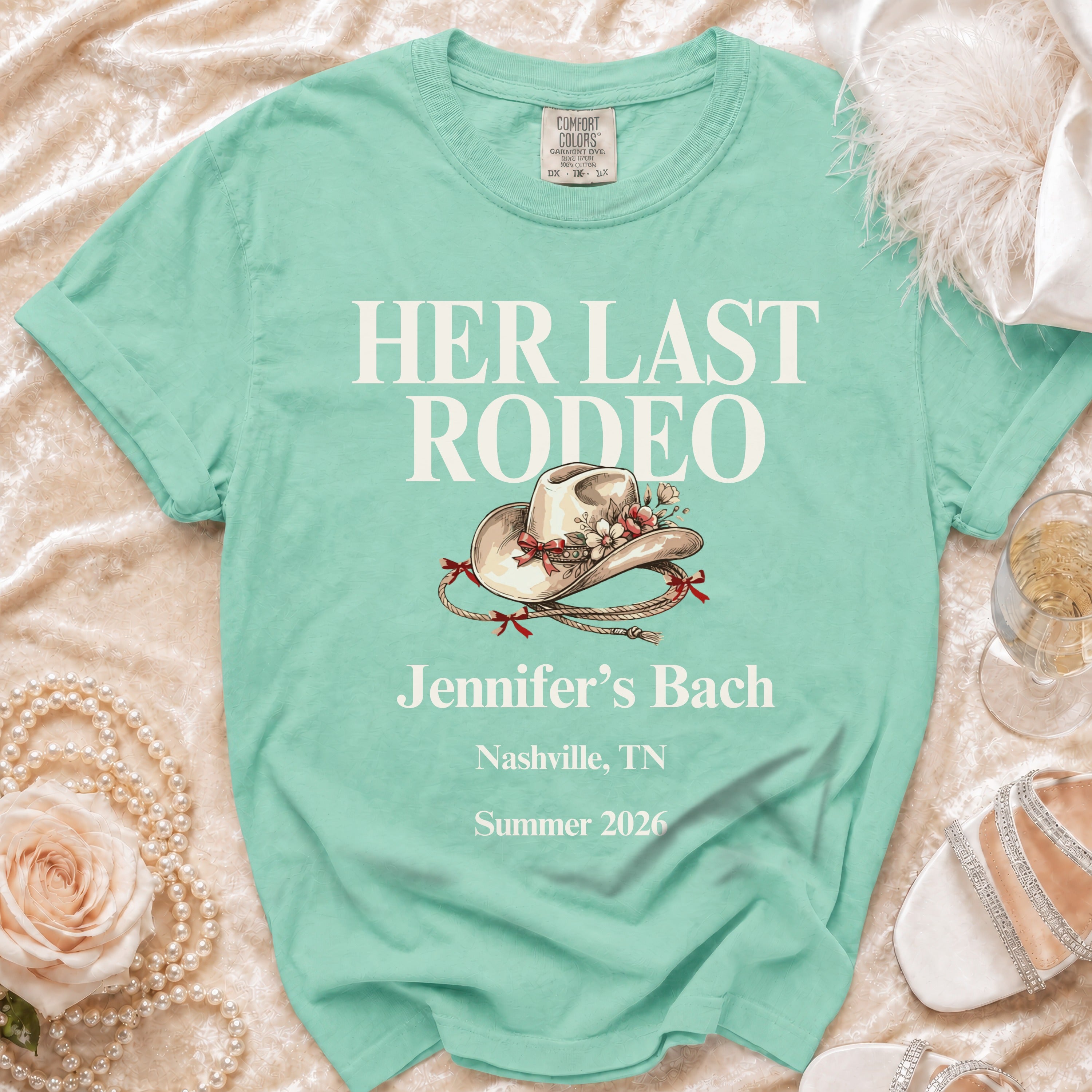 Mint green t-shirt with "Her Last Rodeo" text and rodeo hat graphic.