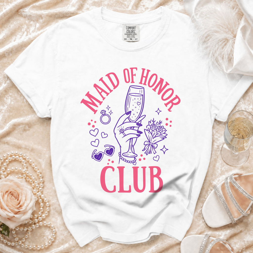 White t-shirt with "Maid of Honor Club" text and graphic of hand holding champagne.