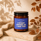 Amber jar candle with blue label reading "Light me when I start crying as I ask you"