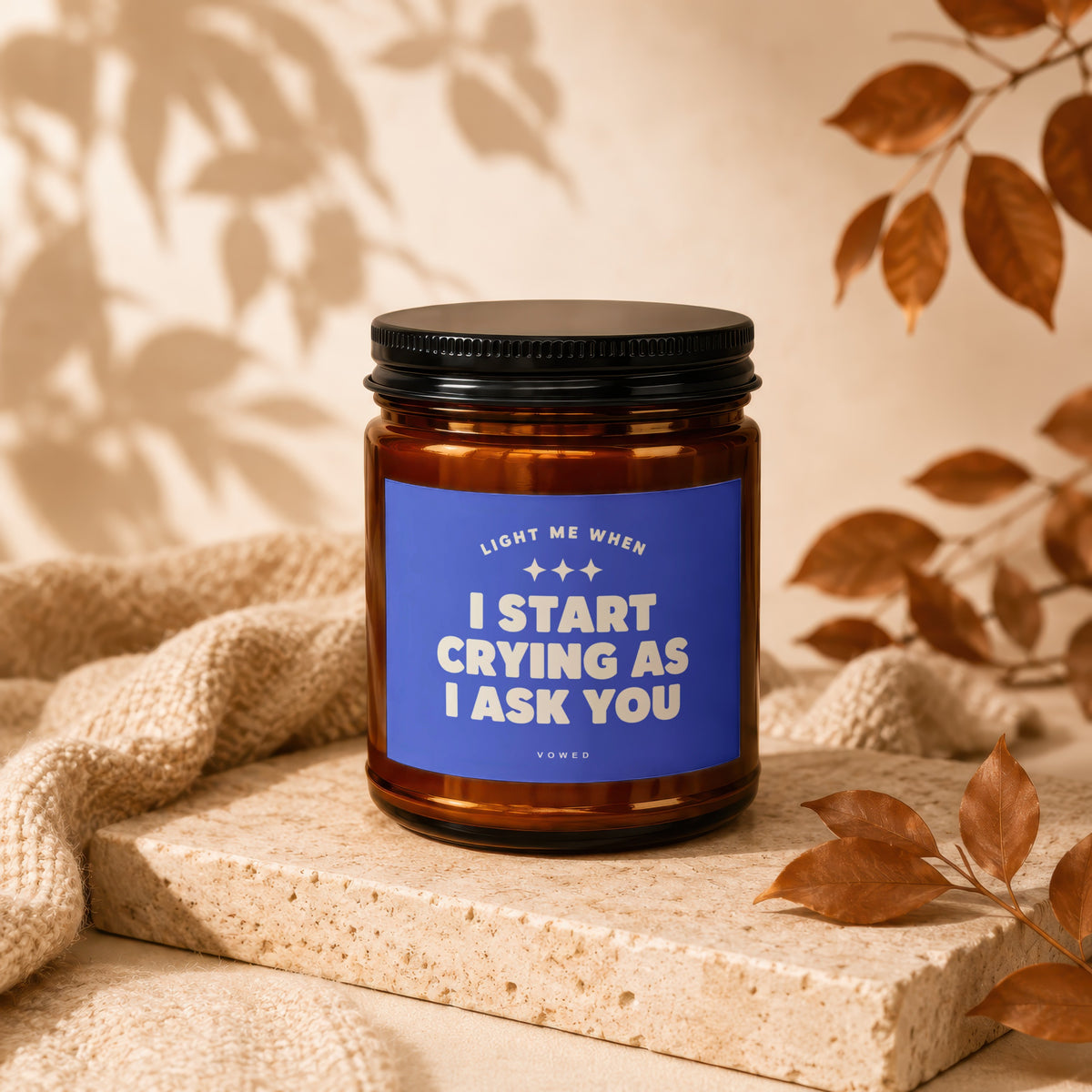 Amber jar candle with blue label reading "Light me when I start crying as I ask you"