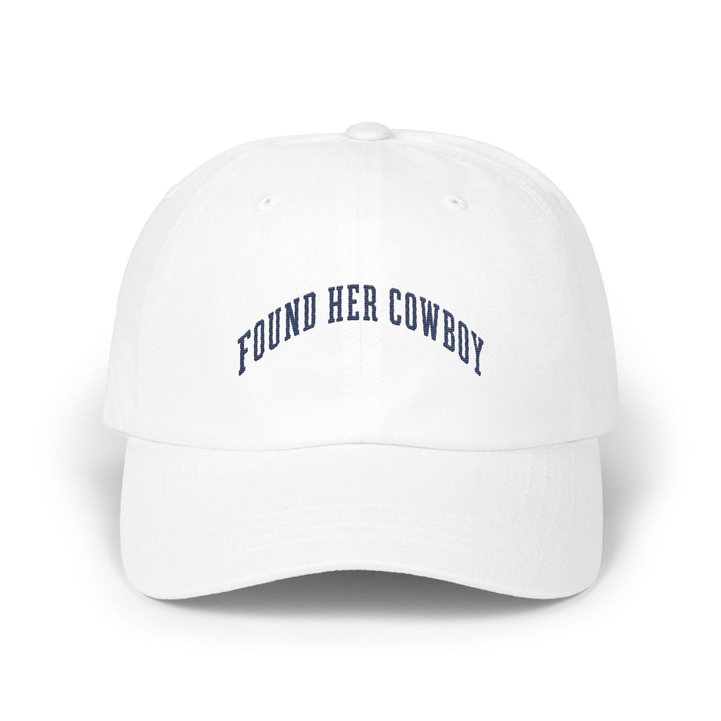 A white baseball cap with the curved blue embroidered text FOUND HER COWBOY.