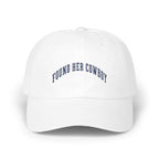 A white baseball cap with the curved blue embroidered text FOUND HER COWBOY.