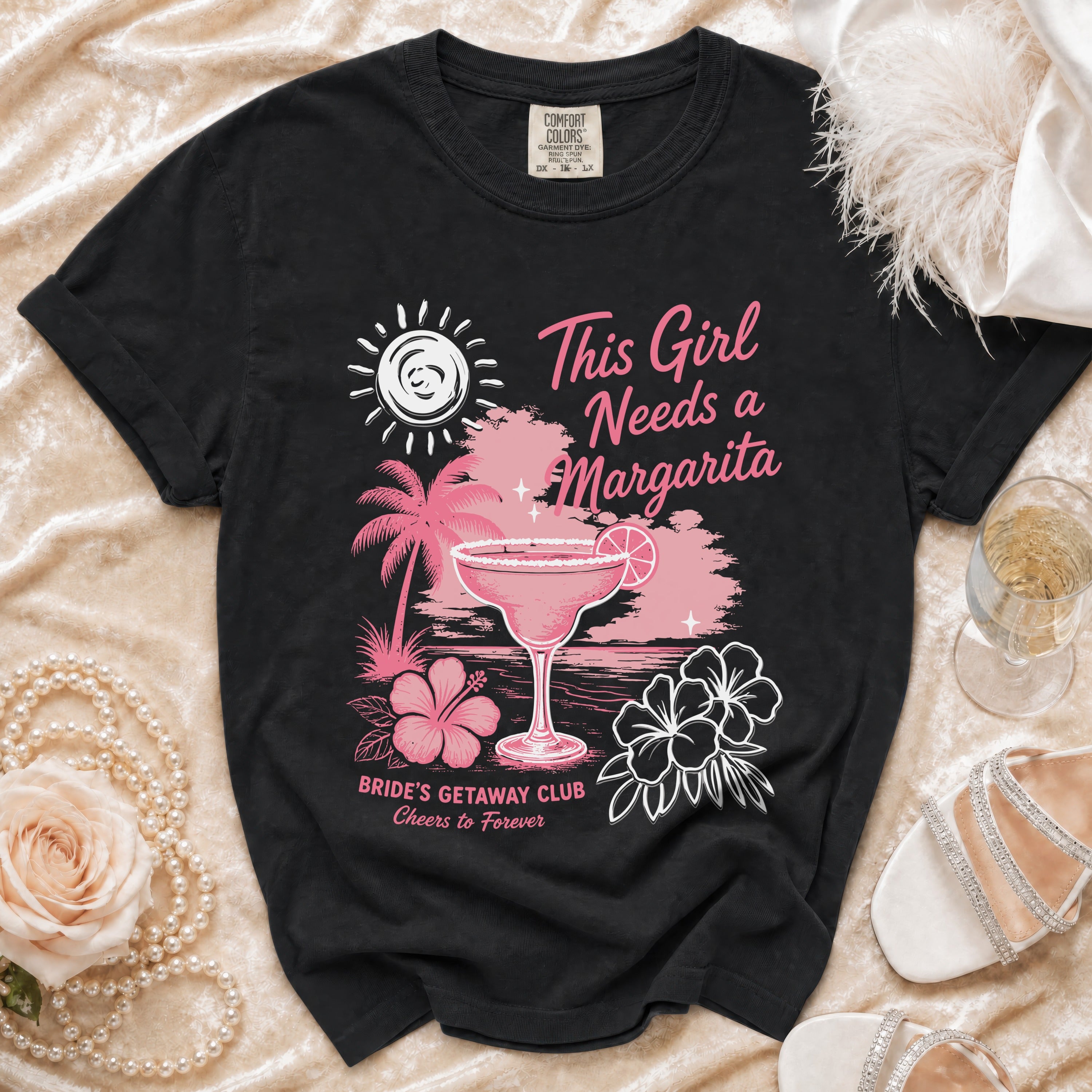 Black t-shirt with a tropical margarita, palm trees, and text: "This Girl Needs a Margarita Bride's Getaway Club Cheers to Forever".