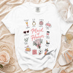 White t-shirt with "Maid of Honor" and decorative icons representing wedding roles.