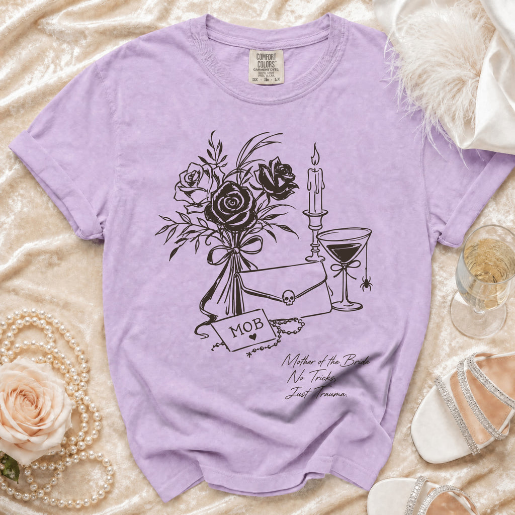 Lavender t-shirt with graphic of roses, clutch, skull, and text "MOB" and "Mother of the Bride No Tricks Just Trauma."