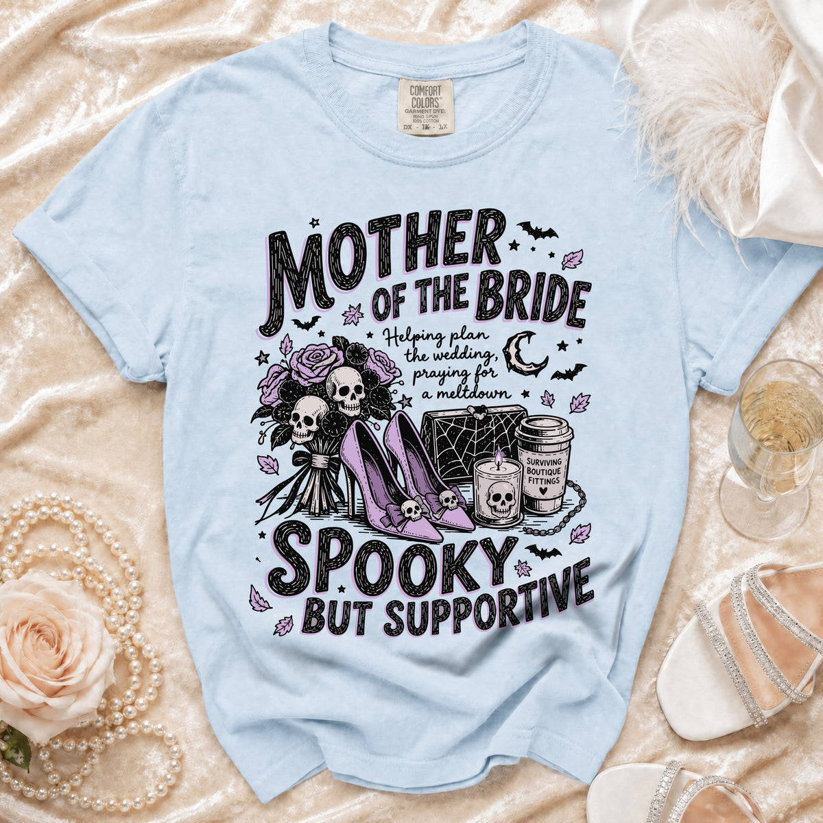 Light blue t-shirt with "Mother of the Bride Spooky But Supportive" graphic.