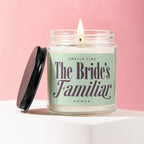 Candle with a lit wick labeled "Smells Like The Bride's Familiar"