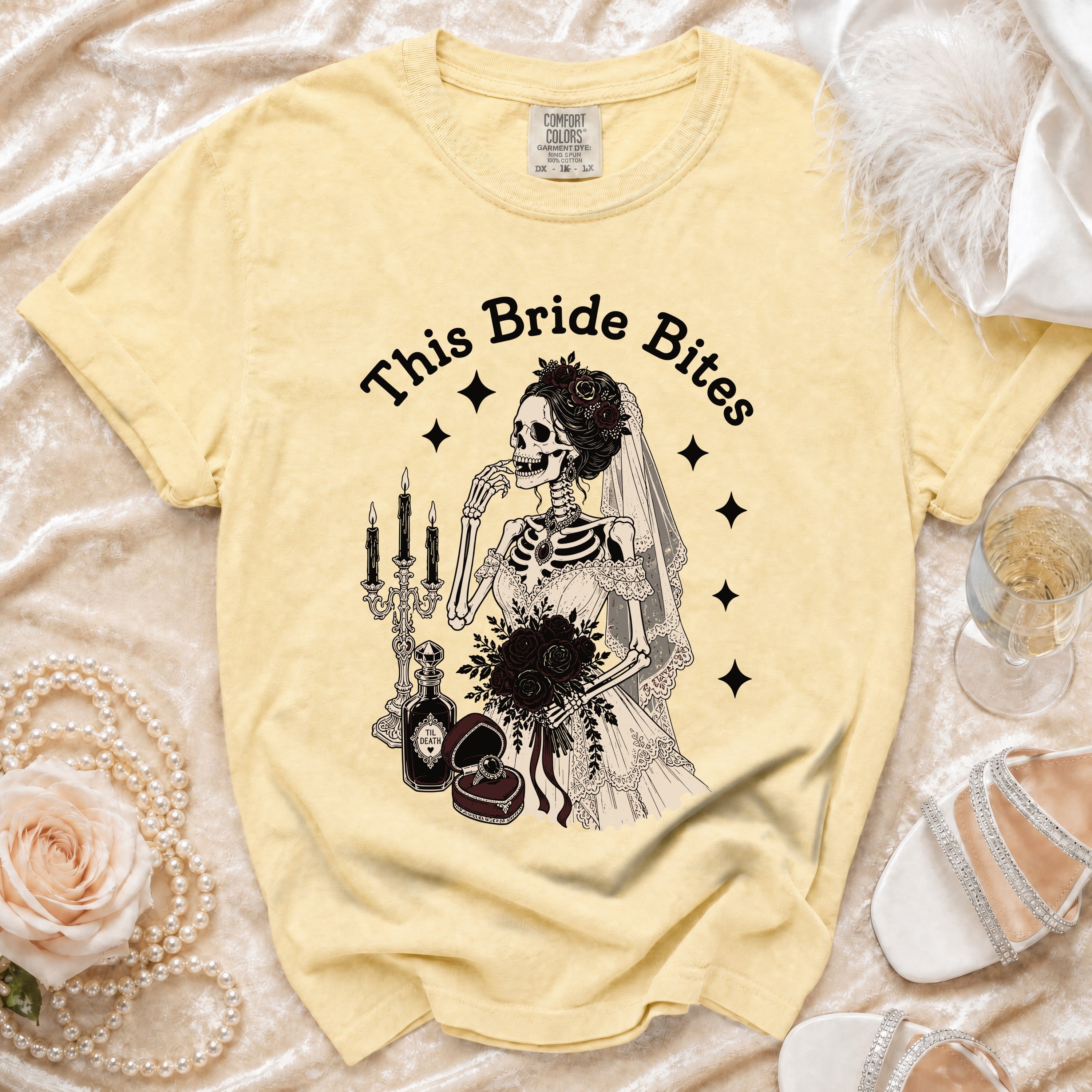 Yellow t-shirt with skeleton bride graphic and text "This Bride Bites".