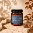 Amber glass candle with blue label that reads "Making Memories Together"