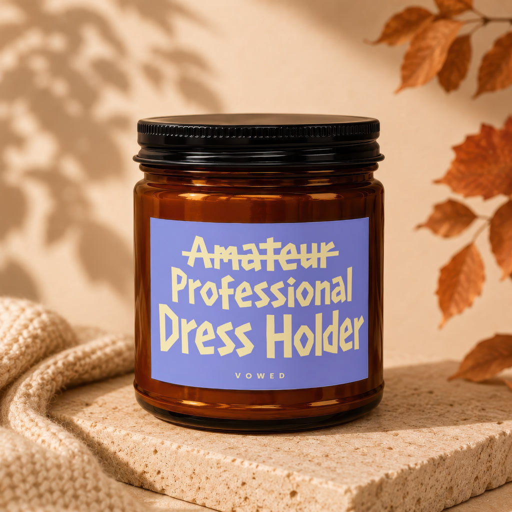 Amber jar with black lid labeled "Amateur Professional Dress Holder."