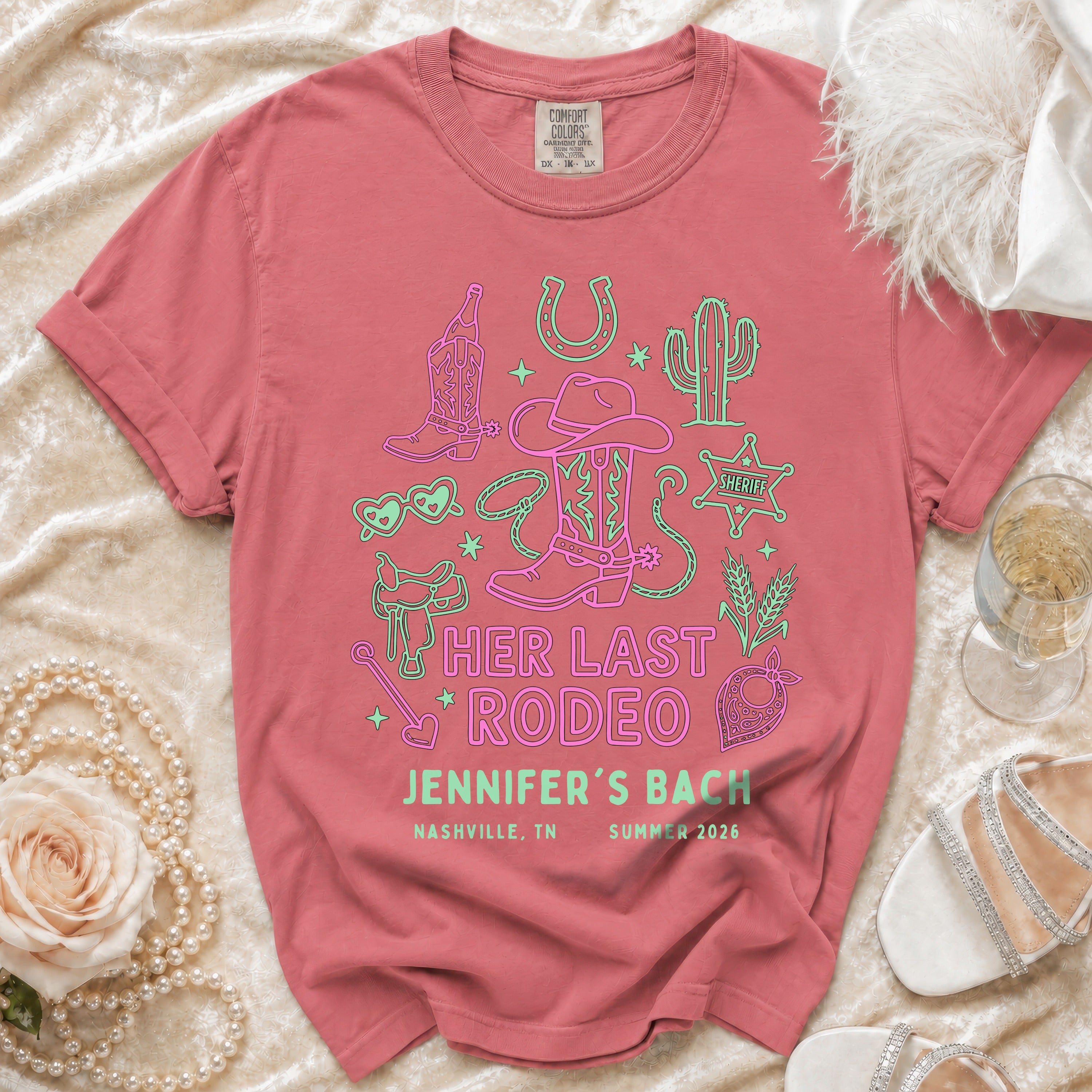 Pink t-shirt with "Her Last Rodeo Jennifer's Bach Nashville, TN Summer 2026" in neon rodeo graphics.
