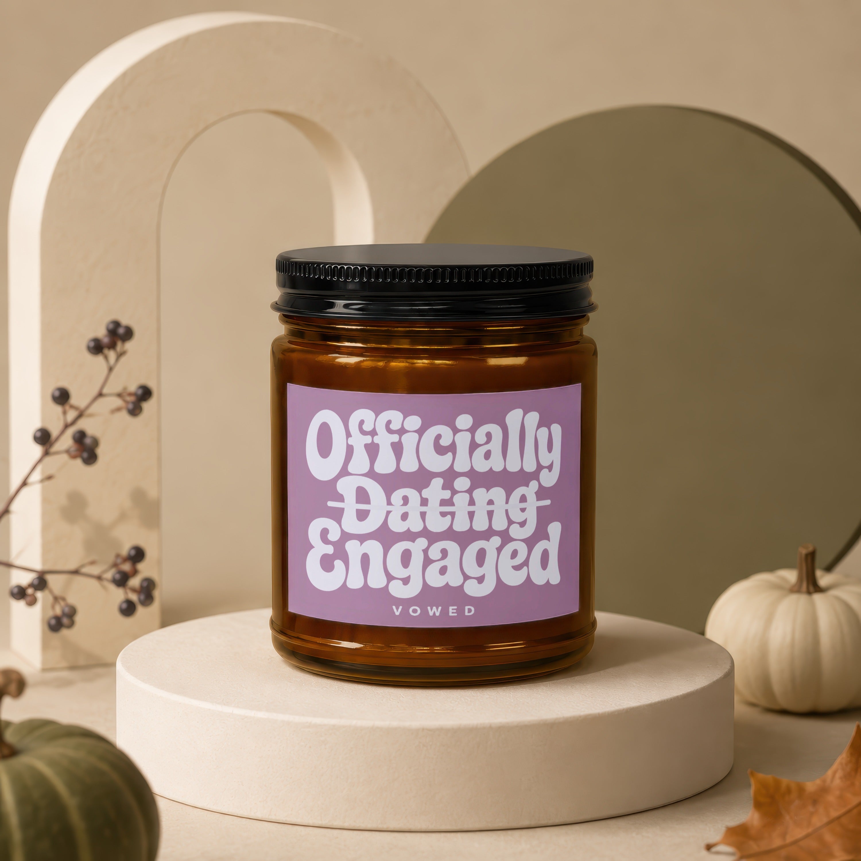 Brown glass candle with "Officially Dating Engaged vOWED" text on a purple label.