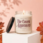 Candle with label "Smells like The Coven Approves".