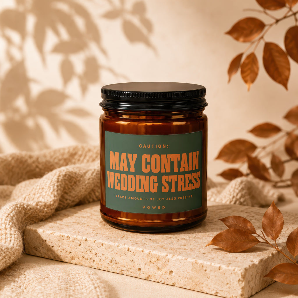 Amber candle with black lid and "May Contain Wedding Stress" label.