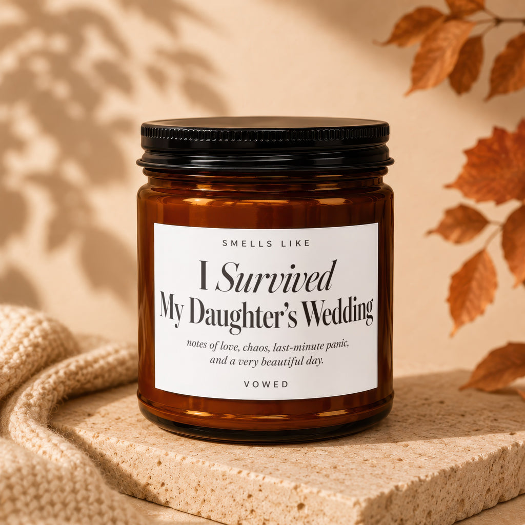 Amber candle with "I Survived My Daughter's Wedding VOWED" label.