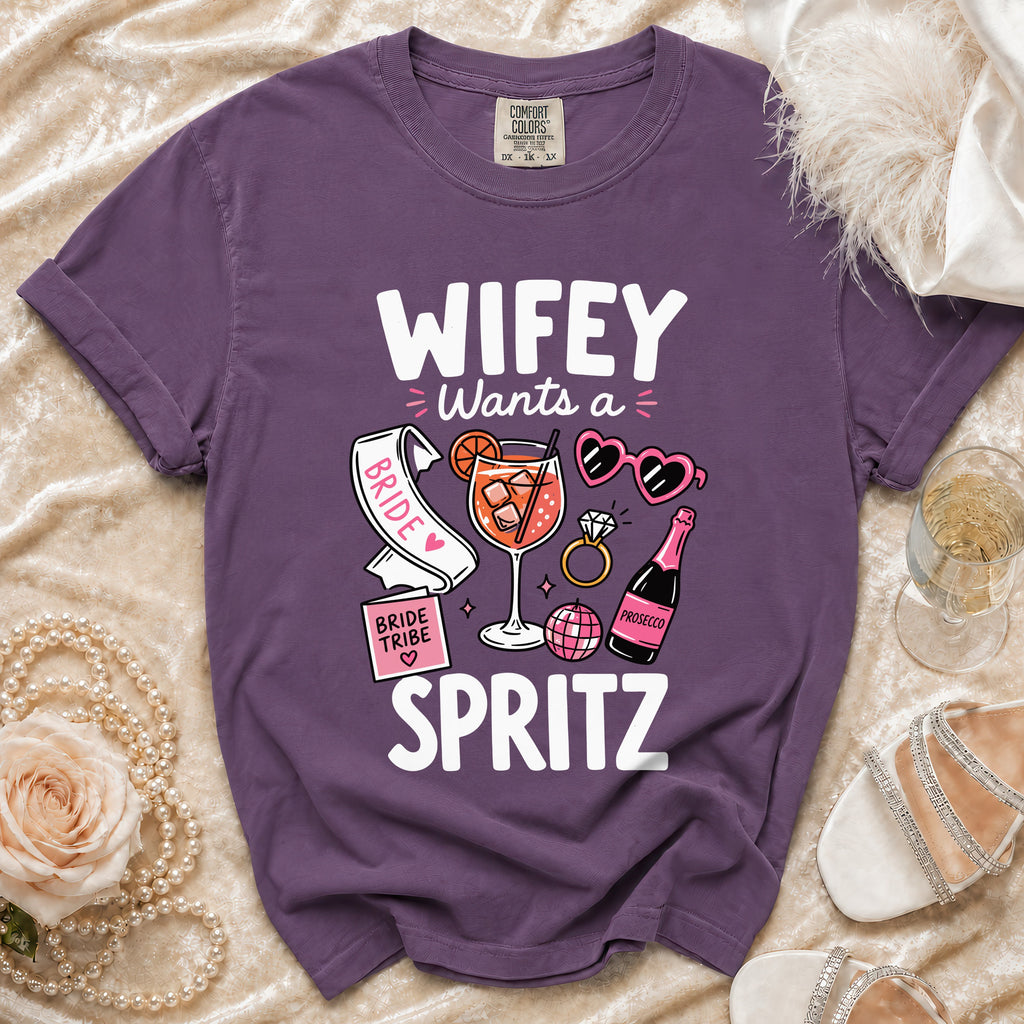 Purple t-shirt with "WIFEY Wants a Spritz" graphic and bachelorette party icons.